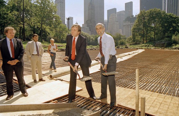New York City Parks Commissioner Henry Stern, right, and real estate mogul Donald Trump, lift shovels of cement to mark the start of concrete pouring in Central Park's Wollman Rink, Sept. 10, 1986. Tr ...