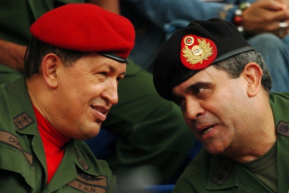 FILE - In this Aug. 11, 2006 file photo, Venezuela&#039;s President Hugo Chavez, left, and his Defense Minister Raul Baduel attend the military reserve changing of command ceremony in Caracas, Venezue ...