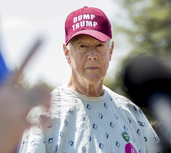 David Barrows of Washington wears a "Dump Trump" hat as Sen. Catherine Cortez Masto, D-Nev. speaks at a Spanish-language news conference to discuss the Senate GOP healthcare bill, Wednesday, ...