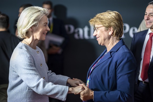 epa11415293 Ursula Von der Leyen, President of the European Commission, (L) shakes hands Swiss Federal President Viola Amherd (C) next to Swiss Federal Councillor Ignazio Cassis (R) during the Summit  ...