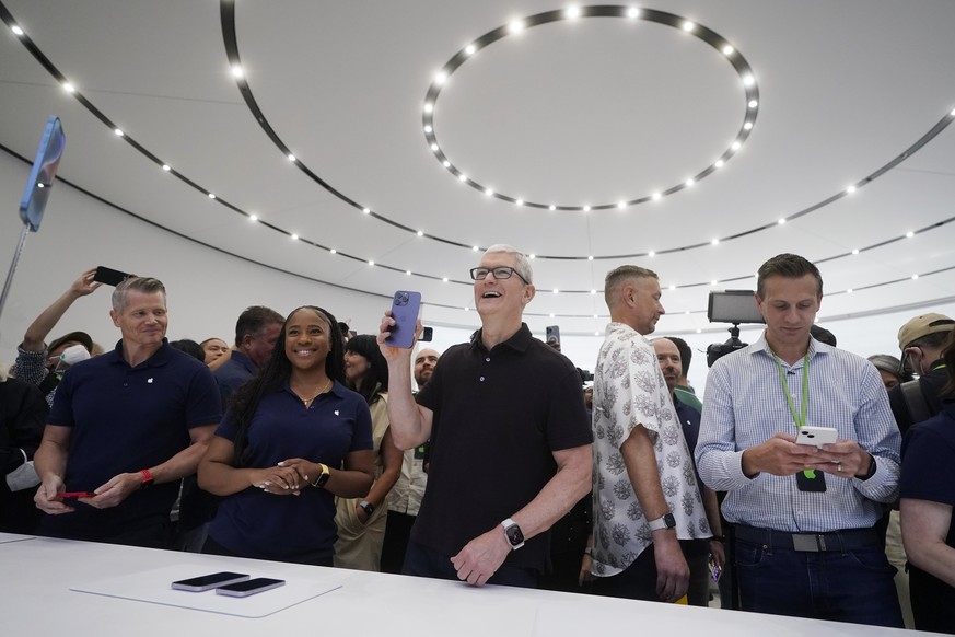 Apple CEO Tim Cook holds a new iPhone model at an Apple event on the campus of Apple&#039;s headquarters in Cupertino, Calif., Wednesday, Sept. 7, 2022. (AP Photo/Jeff Chiu)