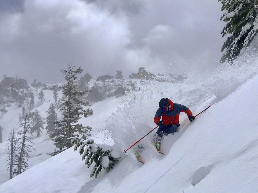 This May 16, 2019 photo provided by Miles Clark shows him taking deep powder on a run at Squaw Valley Ski Resort, Calif., after a late spring storm blanketed the area with snow. Much of California has ...