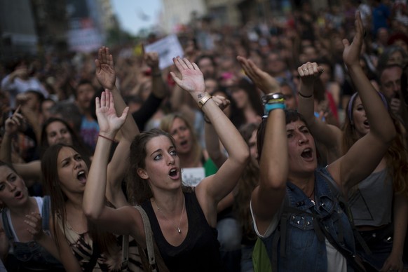 Demonstrators shout slogans during a protest to mark the anniversary of the beginning of the &quot;Indignados&quot; movement in Barcelona, Spain, Saturday May 12, 2012. Spanish activists angered by gr ...