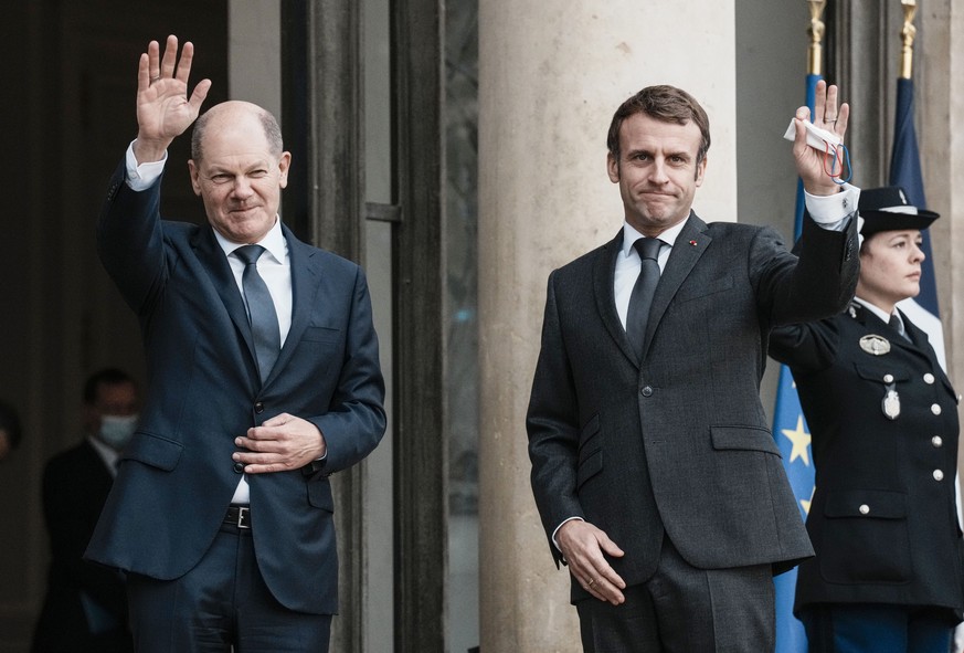 German Chancellor Olaf Scholz, left, is welcomed by French President Emmanuel Macron at the Elysee Palace in Paris, Friday, Dec. 10, 2021. Two days after taking office, Scholz visits the French Presid ...