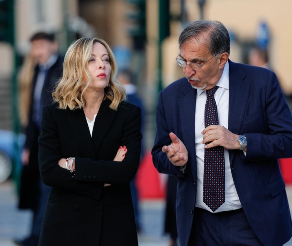 epa11299354 Italian Senate President Ignazio La Russa and Italian Prime Minister Giorgia Meloni (L) talk as they attend a wreath-laying ceremony at the Altar of the Fatherland (Altare della Patria) du ...