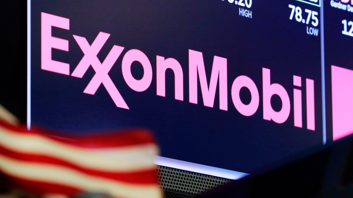 FILE - In this April 23, 2018, file photo, the logo for ExxonMobil appears above a trading post on the floor of the New York Stock Exchange. Exxon Mobil shareholders have unseated a third board member ...
