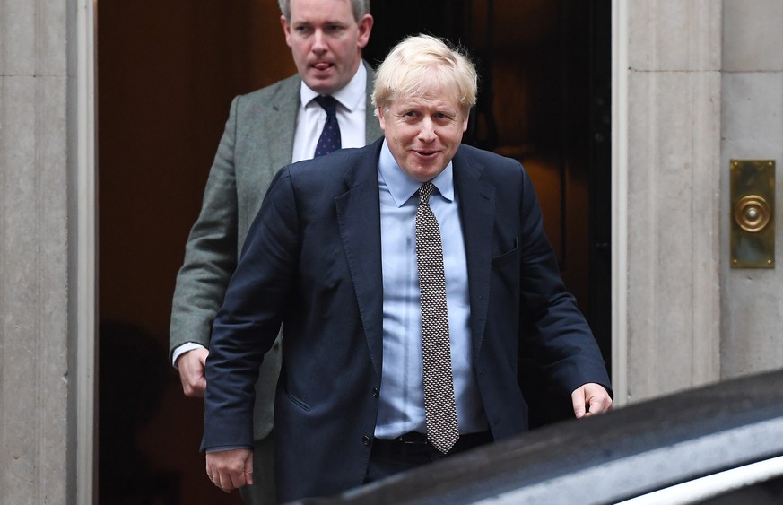 epa07946065 British Prime Minister Boris Johnson (R) departs 10 Downing Street in London, Britain, 24 October 2019. Johnson has stated he is to table a motion for a general election for 12 December. E ...