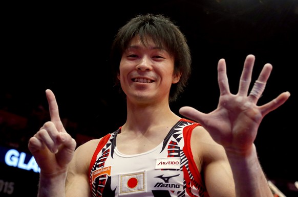 FILE - In this Oct. 30, 2015, file photo, first placed Kohei Uchimura from Japan shows the number of his world championship titles after the men's all-around final competition at the World Artist ...