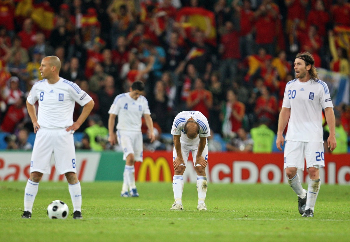Greece's Giannis Amanatidis, Angelos Basinas, Nikos Spiropoulos and Stelios Giannakopoulos, from right, react after the group D match between Greece and Spain in Salzburg, Austria, Wednesday, Jun ...