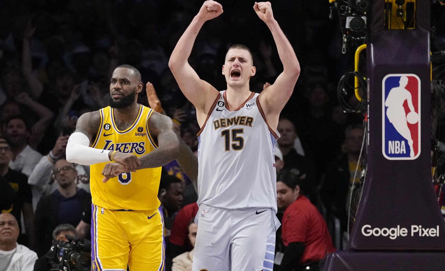 Denver Nuggets center Nikola Jokic (15) celebrates after Los Angeles Lakers forward LeBron James, left, missed a layup attempt as time expired in the second half of Game 4 of the NBA basketball Wester ...