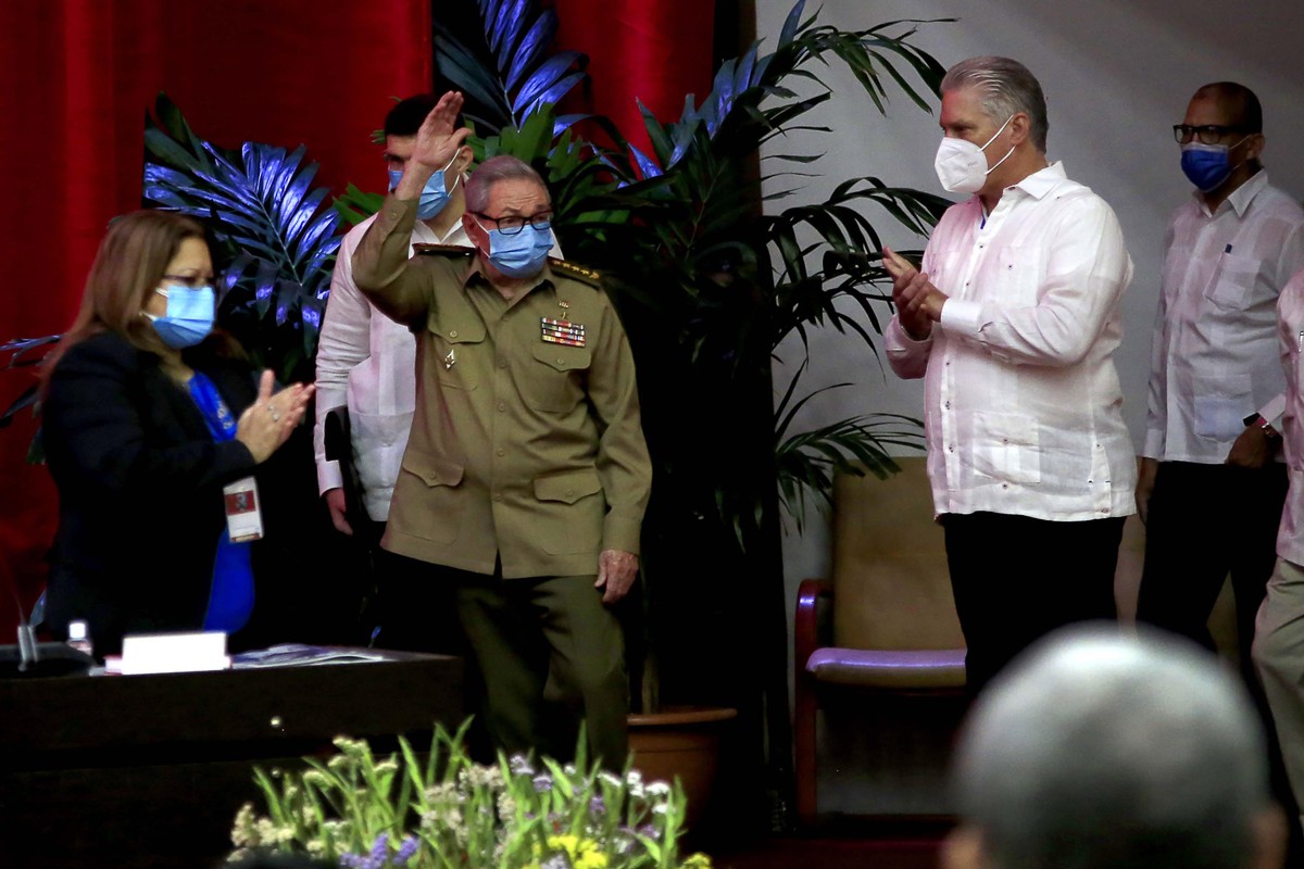 Raul Castro, first secretary of the Communist Party and former president, waves to members at the VIII Congress of the Communist Party of Cuba's opening session, as Cuban President Miguel Diaz-Ca ...