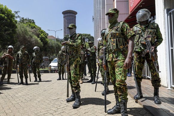 epa11799112 Anti-riot police officers stand guard during a protest by activists against the rise in alleged abductions of government critics, in Nairobi, Kenya, 30 December 2024. The protests across t ...