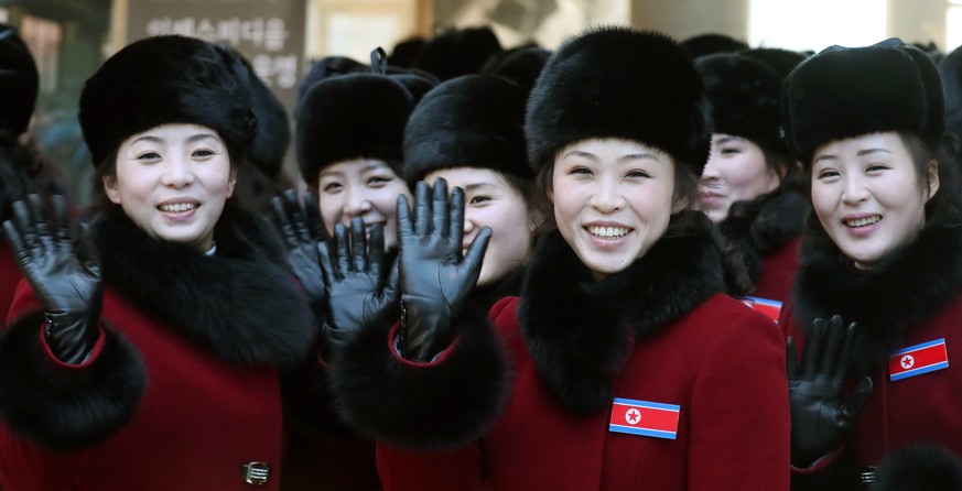 North Korean cheering squads wave upon their arrival at a stadium in Inje, South Korea, Wednesday, Feb. 7, 2018. A North Korean delegation, including members of a state-trained cheering group, arrived ...