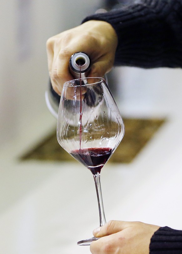 epa04098925 A glass is filled with red wine for a wine tasting at the Vinisud wine fair in Montpellier, France, 24 February 2014. Vinisud is the biggest Mediterranean wine fair where international mer ...
