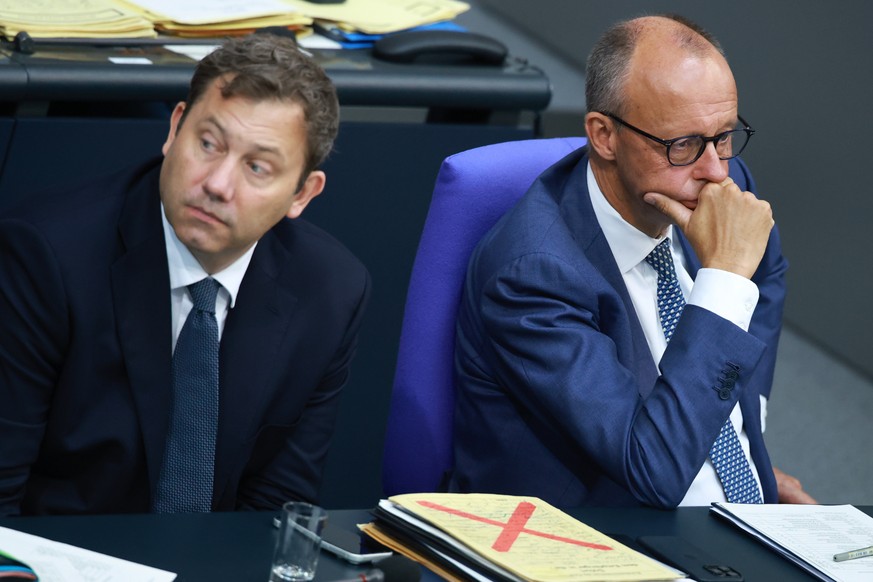 epa13224509 German Chancellor Friedrich Merz (R) looks on next to Finance Minister Lars Klingbeil (L) during a debate at the German parliament, the Bundestag, in Berlin, Germany, 09 September 2026. Me ...