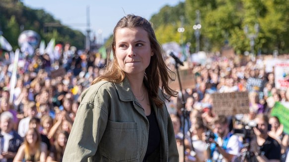 BERLIN, GERMANY - SEPTEMBER 15: Luisa Neubauer, prominent member of the Fridays for Future (FFF) climate action movement speaks to supporters as they gather at the Brandenburg Gate during a worldwide  ...