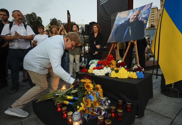 epa12344236 Ukrainians lay flowers to the Andriy Parubiy portrait during the evening of his memories of Andriy Parubiy at the Maidan in downtown Kyiv, Ukraine, 01 September 2025. Andriy Parubiy, 54, a ...