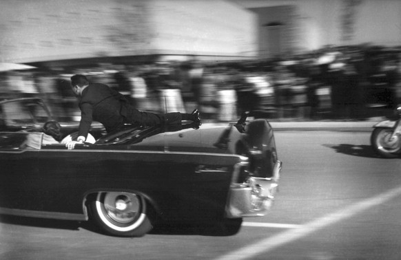 FILE - In this Nov. 22, 1963 file photo, the limousine carrying mortally wounded President John F. Kennedy races toward the hospital seconds after he was shot in Dallas. Secret Service agent Clinton H ...