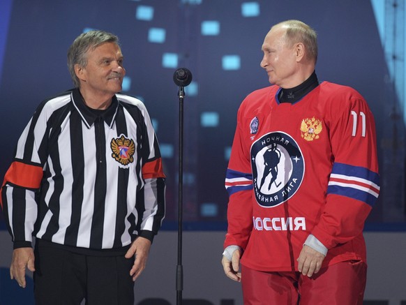 Russian President Vladimir Putin, right, and IIHF President Rene Fasel attend a gala match with the participation of Russian hockey legends as part of the final stage of the X All-Russian Night Hockey ...