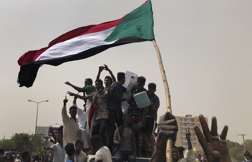 FILE - In this June 30, 2019, file photo, Sudanese protesters shout slogans as they march during a demonstration against the military council, in Khartoum, Sudan. An African Union envoy says Sudan&#03 ...