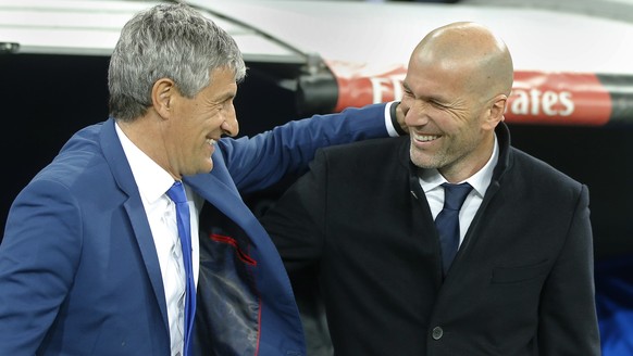Las Palmas coach Quique Setien, left, and Real Madrid&#039;s head coach Zinedine Zidane greet each other before a Spanish La Liga soccer match between Real Madrid and Las Palmas at the Santiago Bernab ...