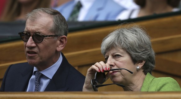Britain&#039;s Prime Minister Theresa May and her husband Philip sit in the Royal Box for the Men&#039;s Singles final match between Switzerland&#039;s Roger Federer and Croatia&#039;s Marin Cilic on  ...