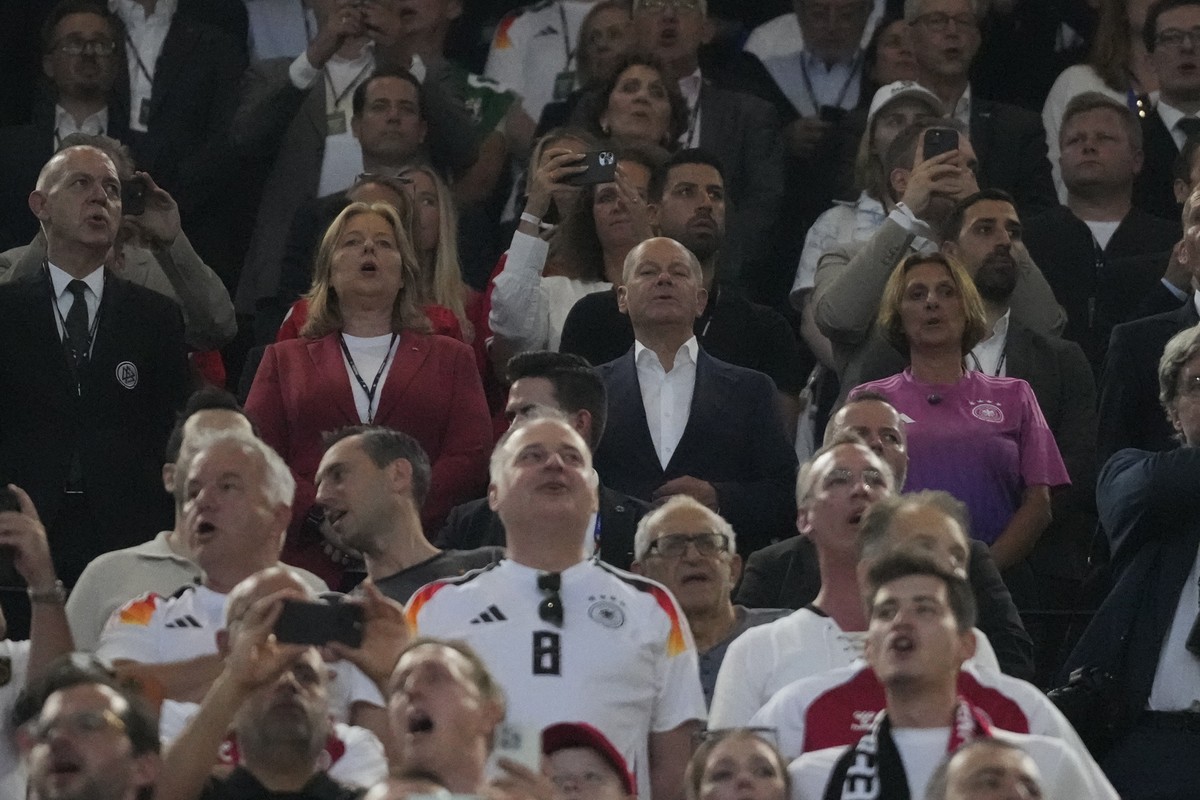Germany's Chancellor Olaf Scholz, center, sings the national anthem before a round of sixteen match between Germany and Denmark at the Euro 2024 soccer tournament in Dortmund, Germany, Saturday,  ...