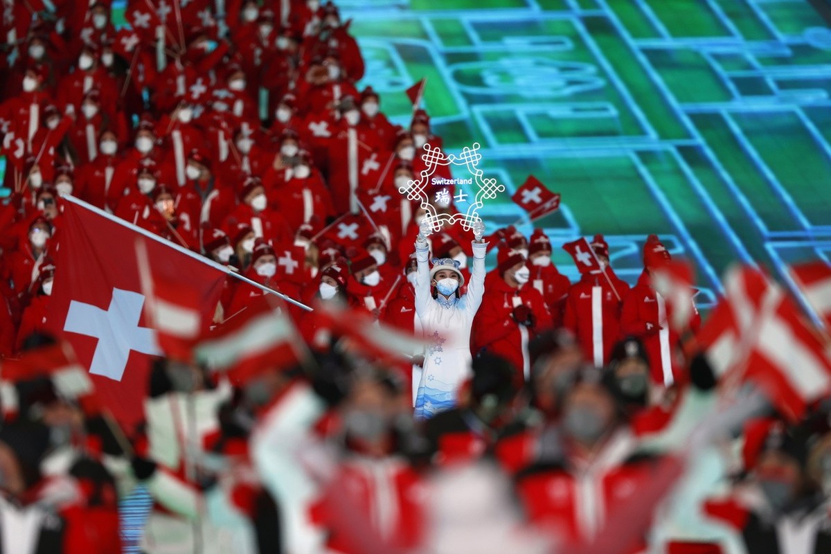 epa09727398 Athletes of Switzerland march during the Opening Ceremony for the Beijing 2022 Olympic Games at the National Stadium, also known as Bird's Nest, in Beijing China, 04 February 2022. EP ...