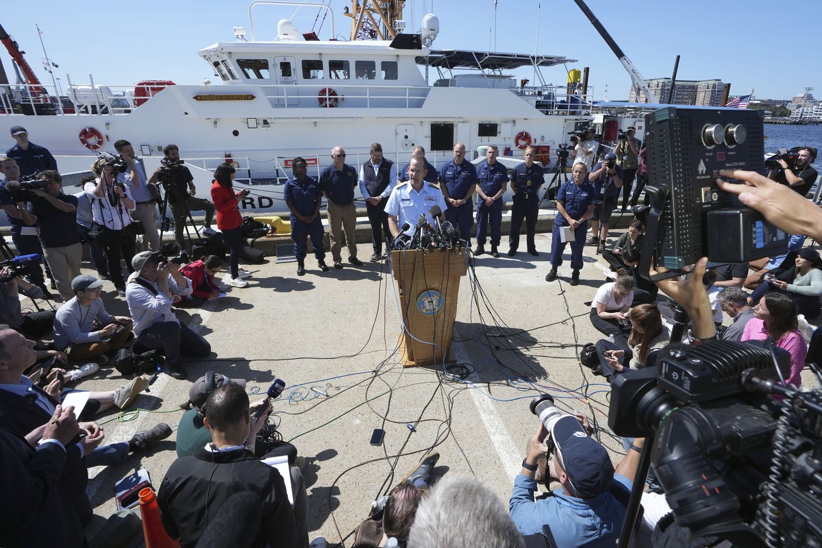 U.S. Coast Guard Rear Adm. John Mauger, commander of the First Coast Guard District, center at microphone, talks to the media Thursday, June 22, 2023, at Coast Guard Base Boston, in Boston. The U.S. C ...