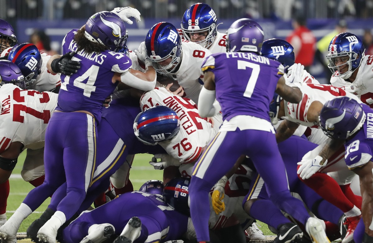 New York Giants' Daniel Jones runs for a first down during the second half of an NFL wild card football game against the Minnesota Vikings Sunday, Jan. 15, 2023, in Minneapolis. (AP Photo/Bruce K ...