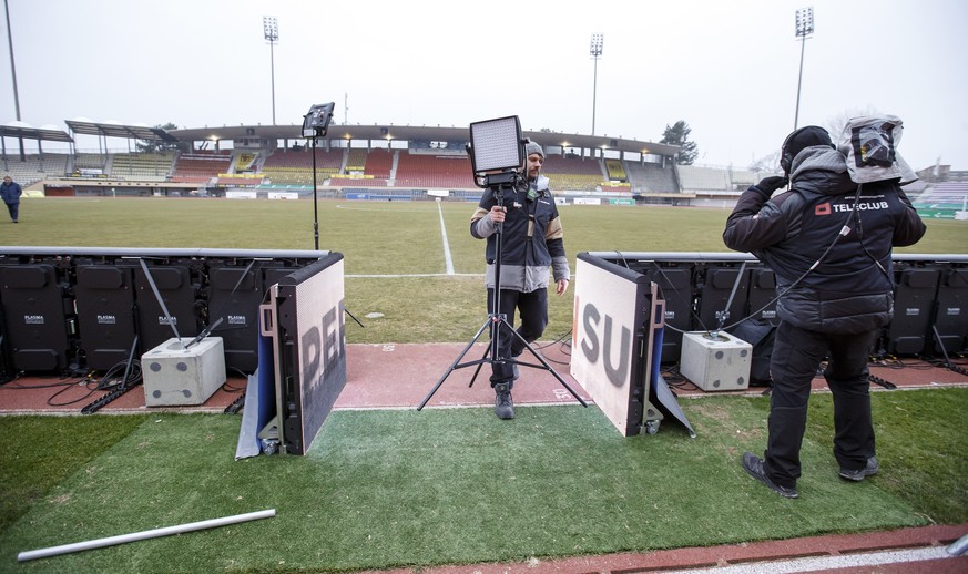 Technicians of the Teleclub remove their equipment after the referee postponed the soccer match of the Super League Swiss Championship between FC Lausanne-Sport and FC Basel because parts of the pitch ...