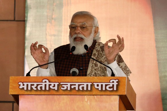 epa08814034 Indian Prime Minister Narendra Modi addresses the gathering at BJP party headquarters in New Delhi, India, 11 November 2020. Leaders and workers of BJP celebrated after the Bharatiya Janat ...