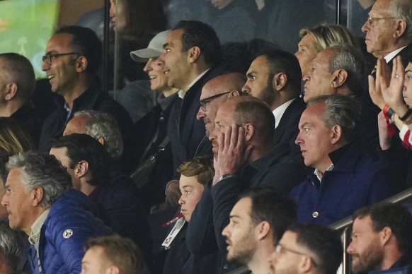 Britain&#039;s Prince William, center, with his son Prince George, reacts after PSG&#039;s Nuno Mendes scored his side&#039;s third goal during the Champions League quarterfinal first leg soccer match ...