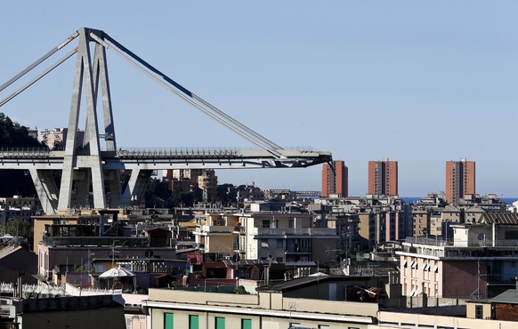 A view of the Morandi highway bridge that collapsed in Genoa, northern Italy, Wednesday, Aug. 15, 2018. A large section of the bridge collapsed over an industrial area in the Italian city of Genova du ...