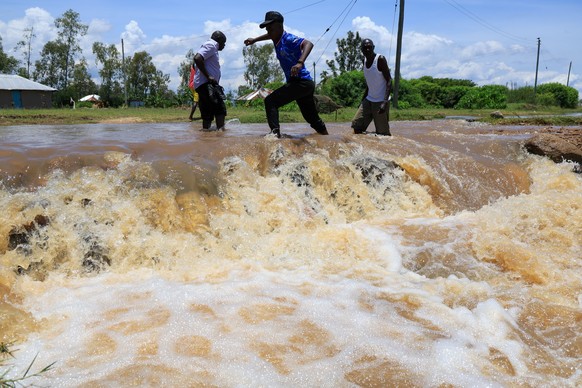 People cross a flooded portion of the road following heavy rains in Nyakach, Western Kenya, Tuesday, March 24, 2026. (AP Photo/Andrew Kasuku)
Kenya Floods