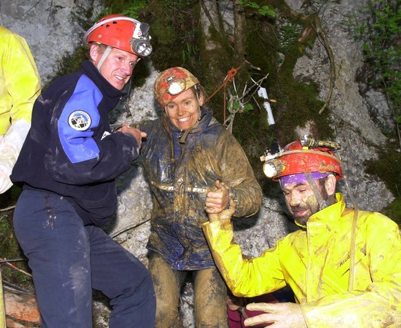 One of the eight Swiss students, center, who were trapped in the cave 'Bief Paroux' in Goumois, France, smiles as she comes out of the cave Saturday evening, May 19, 2001. Rescuers delayed a bid on Fr ...