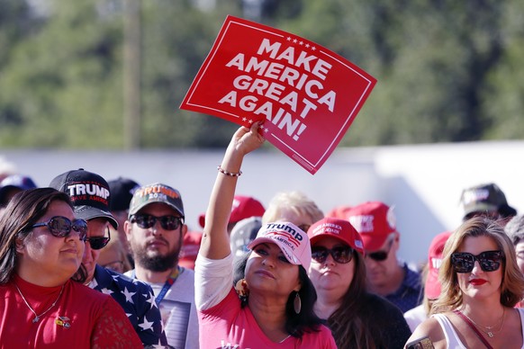 An attendee holds up a MAGA sign as the crowd waits for former President Donald Trump to deliver remarks during a campaign event held at Trendsetter Engineering on Thursday, Nov. 2, 2023, in Houston.  (AP phone...
