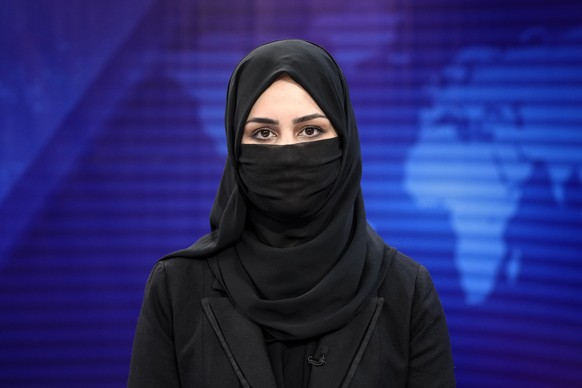 Khatereh Ahmadi a TV anchor reads news on TOLO NEWS studio while covering her face, in Kabul, Afghanistan, Sunday, May 22, 2022. Afghanistan&#039;s Taliban rulers have begun enforcing an order requiri ...