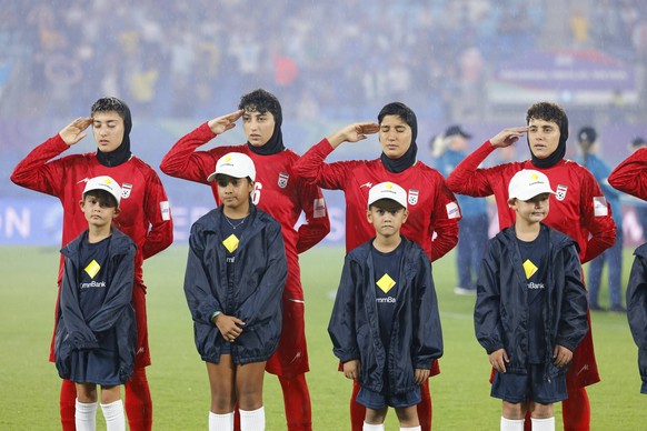 GOLD COAST, AUSTRALIA - MARCH 08 Players of IR Iran salute the national anthem before the Womens Asian Cup match between Islamic Republic of Iran and Philippines at the Gold Coast Stadium on March 08  ...