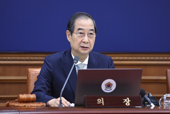 South Korea&#039;s Prime Minister Han Duck-soo, who became the country&#039;s acting leader after President Yoon Suk Yeol&#039;s impeachment, speaks during a cabinet meeting at the government complex  ...