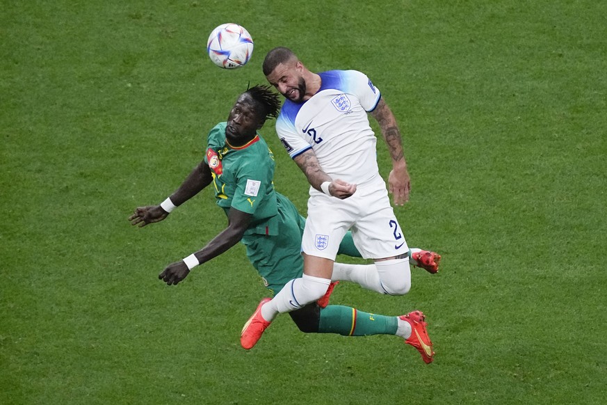 Senegal&#039;s Moussa Ndiaye, left, and England&#039;s Kyle Walker vie for the ball during the World Cup round of 16 soccer match between England and Senegal, at the Al Bayt Stadium in Al Khor, Qatar, ...