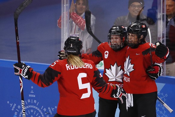 epa06515039 Renata Fast (C) of Canada celebrates with teammates Lauriane Rougeau (L) and Meaghan Mikkelson (R) after scoring a goal during the Women&#039;s Ice Hockey match between Canada and the Olym ...