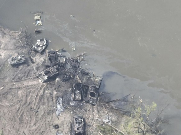 In this handout photo provided by the Ukraine Armed Forces Thursday, May 12, 2022, dozens of destroyed or damaged Russian armored vehicles on both banks of Siverskyi Donets River after their pontoon b ...