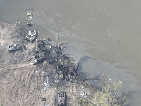 In this handout photo provided by the Ukraine Armed Forces Thursday, May 12, 2022, dozens of destroyed or damaged Russian armored vehicles on both banks of Siverskyi Donets River after their pontoon b ...