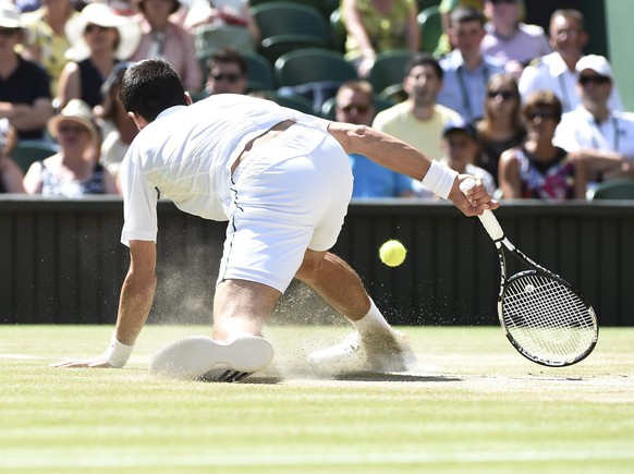 epa04840741 Novak Djokovic of Serbia plays Richard Gasquet of France in their semi final match during the Wimbledon Championships at the All England Lawn Tennis Club, in London, Britain, 10 July 2015. ...