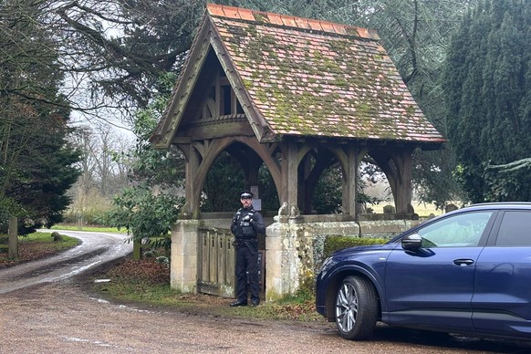 A police officer guards the entrance to Chruchyard of the Sandringham Royal Estate in Sandringham, Thursday, Feb. 19, 2026 after Andrew Mountbatten-Windsor has been arrested by British police on suspi ...
