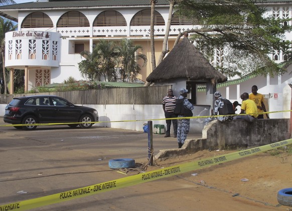 FILE - A road leading to the Etoile du Sud Hotel, seen in the background, has been cordoned off near the site of an attack in Grand-Bassam, Ivory Coast, on March 15, 2016. Eleven people have been convicted ...