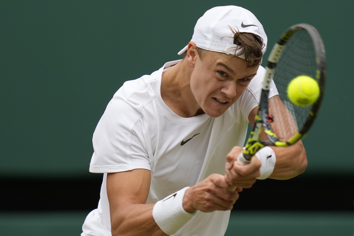 FILE - Denmark's Holger Rune returns in a men's singles match on day ten of the Wimbledon tennis championships in London, Wednesday, July 12, 2023. Boris Becker is returning to coaching on t ...