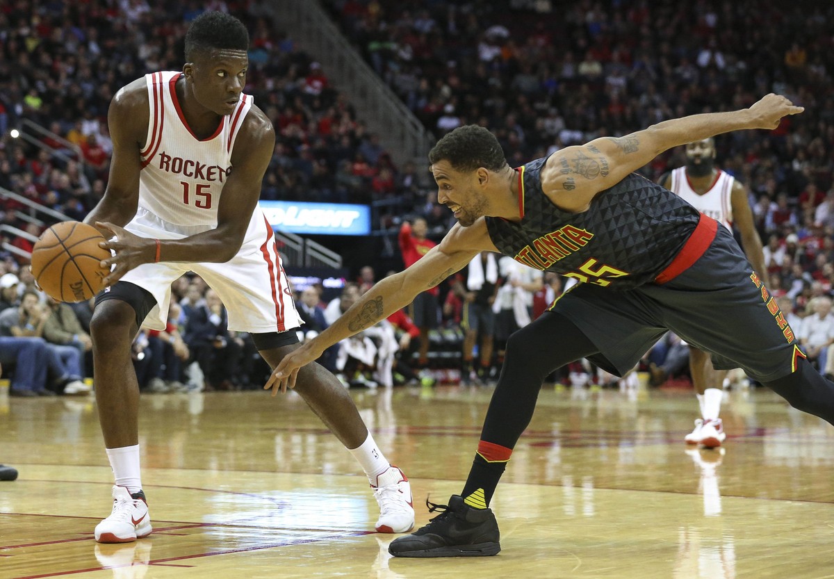 Dec 29, 2015; Houston, TX, USA; Houston Rockets forward Clint Capela (15) controls the ball as Atlanta Hawks forward Thabo Sefolosha (25) defends during the fourth quarter at Toyota Center. The Hawks  ...