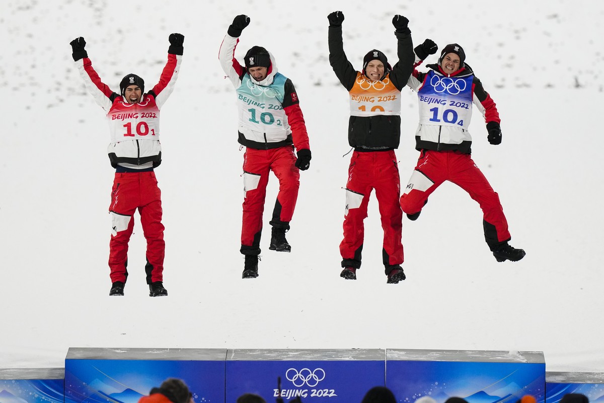 Stefan Kraft, of Austria, left, poses with Daniel Huber, second from left, Jan Hoerl, and Manuel Fettner, right after they won gold in the during a men's team ski jumping event at the 2022 Winter ...
